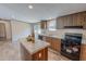 Modern kitchen featuring an island, wooden cabinetry, and updated appliances at 1326 Stephens Dr, Roxboro, NC 27573