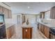 Spacious kitchen with an island and stainless appliances, connected to the living area at 1326 Stephens Dr, Roxboro, NC 27573