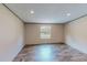 Bright living room featuring wood-look flooring, a large window, and neutral wall colors at 1326 Stephens Dr, Roxboro, NC 27573