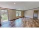 Well-lit living room with wood-look flooring and two windows at 1326 Stephens Dr, Roxboro, NC 27573