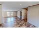 Open-concept living room with wood-look floors and natural light from large windows at 1326 Stephens Dr, Roxboro, NC 27573