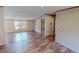 Open-concept living room with wood floors and neutral walls, flowing seamlessly into the kitchen area at 1326 Stephens Dr, Roxboro, NC 27573