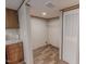 Walk-in closet with shelving, wood-look flooring, and adjacent to kitchen area at 1326 Stephens Dr, Roxboro, NC 27573