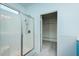 Bright bathroom with a glass-enclosed shower, white tile accent, and walk-in closet access at 135 Brocks Trce, Burlington, NC 27215