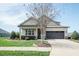Well-maintained home featuring a neat front lawn, flowerbeds, and a driveway at 135 Brocks Trce, Burlington, NC 27215