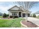 Lovely home featuring a well-manicured lawn, a driveway, and vibrant flowerbeds at 135 Brocks Trce, Burlington, NC 27215
