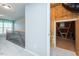 Hallway with neutral walls, carpet, and a view of the finished attic and banister with metal balusters at 135 Brocks Trce, Burlington, NC 27215