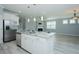 Modern kitchen island with granite countertop, stainless steel appliances, and open floor plan at 135 Brocks Trce, Burlington, NC 27215
