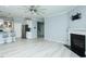 Open-concept living room featuring light gray floors, fireplace, and kitchen access at 135 Brocks Trce, Burlington, NC 27215