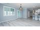 Open living space featuring light gray floors, kitchen access and a glass paneled exterior door at 135 Brocks Trce, Burlington, NC 27215