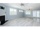 Bright living room features a fireplace, light gray floors, and large windows at 135 Brocks Trce, Burlington, NC 27215