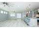 Open-concept living room showcasing modern light fixtures and a kitchen island with seating at 135 Brocks Trce, Burlington, NC 27215