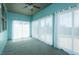 Sunroom with teal walls, carpet, and large windows providing plenty of natural light at 135 Brocks Trce, Burlington, NC 27215