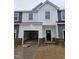 Charming two-story townhome with a brick foundation, an attached garage, and a modern design at 1352 Bessie Ct, Wake Forest, NC 27587