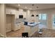 Bright, modern kitchen featuring an island with a sink and white cabinets with black hardware at 1352 Bessie Ct, Wake Forest, NC 27587