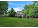 Expansive backyard features a large deck, lush lawn, and a playset, perfect for outdoor entertainment at 1404 Rhea Dr, Garner, NC 27529