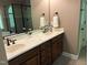 Bathroom with dual sinks, granite countertop, dark wood cabinets, and tile flooring at 1404 Rhea Dr, Garner, NC 27529