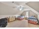 Upstairs bedroom offers two beds, a ceiling fan, and natural light from a window at 1404 Rhea Dr, Garner, NC 27529