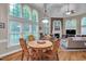 Bright breakfast area with large windows, a round table, and seamless access to living room at 1404 Rhea Dr, Garner, NC 27529