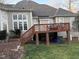 Back of home with deck, patio, and large windows at 1404 Rhea Dr, Garner, NC 27529