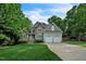 Charming two-story home boasts a stone and siding exterior, lush landscaping, and a two-car garage at 1404 Rhea Dr, Garner, NC 27529