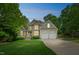 Charming two-story home with stone accents, well-manicured lawn, mature trees and a two car garage at 1404 Rhea Dr, Garner, NC 27529