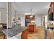 Open-concept kitchen featuring granite counters, a central island and views to breakfast area at 1404 Rhea Dr, Garner, NC 27529