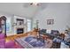 Vaulted living room featuring a brick fireplace, hardwood floors and a seating area at 1404 Rhea Dr, Garner, NC 27529