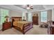 Inviting main bedroom features a large bed, dresser, ceiling fan, and multiple windows at 1404 Rhea Dr, Garner, NC 27529