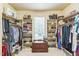 Organized walk-in closet featuring shelving for shoes, clothes and personal items at 1404 Rhea Dr, Garner, NC 27529