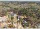 Aerial view of houses featuring new construction home with pool nestled among trees at 1425 Lake Adventure Ct, Raleigh, NC 27613