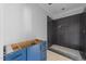 Stylish bathroom showcasing a dark tiled shower and blue vanity, offering a modern aesthetic at 1425 Lake Adventure Ct, Raleigh, NC 27613