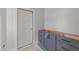 Bathroom featuring painted vanity with drawers and a door at 1425 Lake Adventure Ct, Raleigh, NC 27613