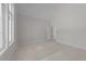 Spacious bedroom with high ceilings, neutral paint, large windows, and adjacent doorway at 1425 Lake Adventure Ct, Raleigh, NC 27613