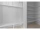 Walk-in closet with a built-in bench and shelving providing ample storage and organization space at 1425 Lake Adventure Ct, Raleigh, NC 27613
