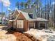 A large new home is displayed, featuring a two-car garage and a mix of gray siding with brick accents at 1425 Lake Adventure Ct, Raleigh, NC 27613