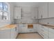 Bright kitchen with white cabinets and natural light, awaiting final fixtures at 1425 Lake Adventure Ct, Raleigh, NC 27613