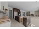 Open-concept kitchen and living space with dark cabinetry and modern design at 1425 Lake Adventure Ct, Raleigh, NC 27613