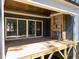 Covered porch featuring wooden floors, a fireplace, and sliding glass doors to the house at 1425 Lake Adventure Ct, Raleigh, NC 27613
