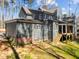 Back exterior view of the home showing gray siding, brick accents, and a covered porch at 1425 Lake Adventure Ct, Raleigh, NC 27613