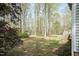 A spacious backyard with a shed, green grass, and various trees surrounding the property at 1508 Middle Ridge Dr, Willow Springs, NC 27592