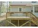 Wood backyard deck with steps going down to the yard and house with light gray siding at 1508 Middle Ridge Dr, Willow Springs, NC 27592