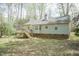 Backyard featuring a wood deck and light gray siding house with a chimney at 1508 Middle Ridge Dr, Willow Springs, NC 27592