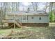 Backyard with a wood deck and light gray siding house with a chimney at 1508 Middle Ridge Dr, Willow Springs, NC 27592