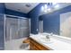 Bathroom features a sink with cabinetry and a shower/tub combo with sliding door at 1508 Middle Ridge Dr, Willow Springs, NC 27592