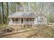 Charming single-story home with a welcoming front porch and mature trees at 1508 Middle Ridge Dr, Willow Springs, NC 27592