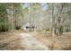 Secluded home surrounded by mature trees, offering privacy and natural beauty at 1508 Middle Ridge Dr, Willow Springs, NC 27592