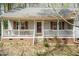 Inviting front porch with a cozy swing and charming curb appeal at 1508 Middle Ridge Dr, Willow Springs, NC 27592