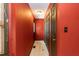 Hallway features a closet, door and a dark red accent wall with light-colored flooring at 1508 Middle Ridge Dr, Willow Springs, NC 27592