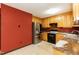 Spacious kitchen features stainless steel refrigerator, black oven and light wood cabinetry at 1508 Middle Ridge Dr, Willow Springs, NC 27592